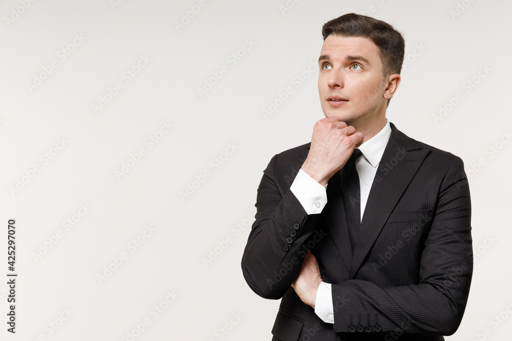Young caucasian pensive employee business corporate lawyer man 20s wear classic formal black grey suit shirt tie work in office prop up chin look aside isolated on white background studio portrait Young caucasian pensive employee business corporate lawyer man 20s wear classic formal black grey suit shirt tie work in office prop up chin look aside isolated on white background studio portrait