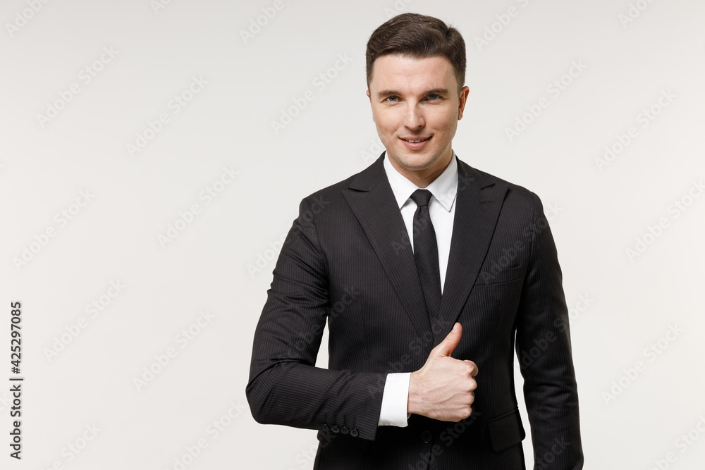 Young caucasian successful employee business corporate lawyer man in classic formal black grey suit shirt tie work in office show thumb up like gesture isolated on white background studio portrait Young caucasian successful employee business corporate lawyer man in classic formal black grey suit shirt tie work in office show thumb up like gesture isolated on white background studio portrait