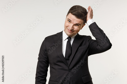 Young puzzled troubled confused employee business corporate lawyer man 20s wearing classic formal black grey suit shirt tie work in office sctratch head isolated on white background studio portrait