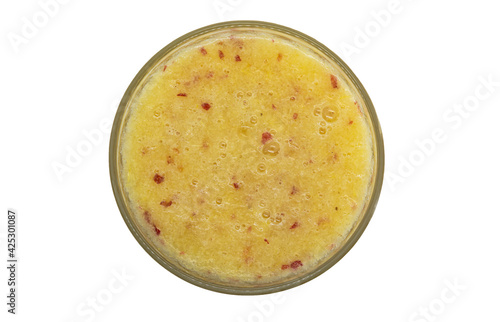 fruit smoothie in a glass on a white background closeup top view