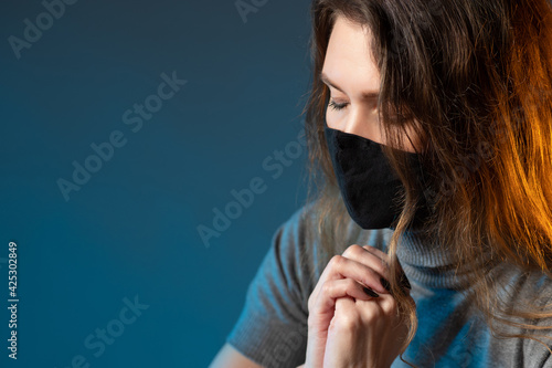 Woman in medical mask prayi...