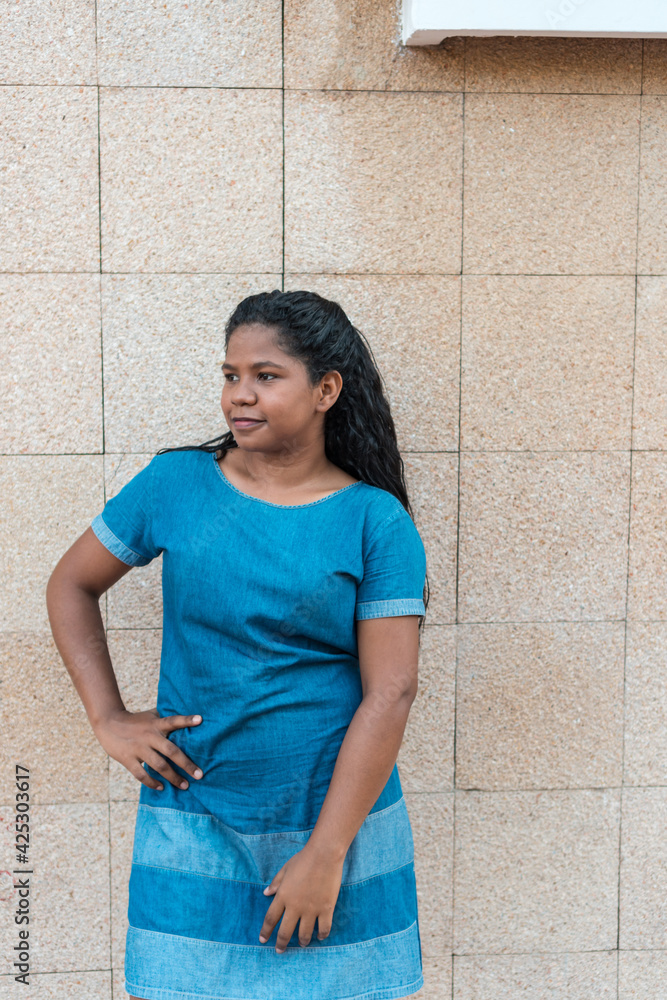Side portrait of smiling young black woman standing outside Side portrait of smiling young black woman standing outside