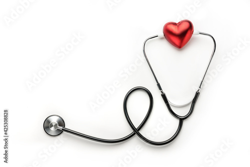 Red heart and medical stethoscope on a white background with copy space.