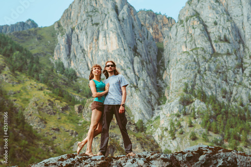 guy with a girl on the background of mountains
