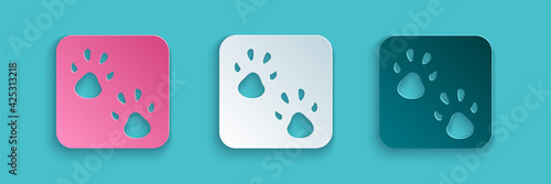 Paper cut Paw print icon isolated on blue background. Dog or cat paw print. Animal track. Paper art style. Vector