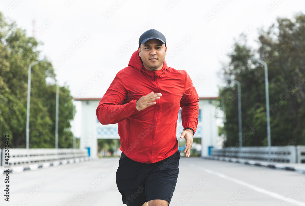 Young asian man wearing sportswear running outdoor. Portraits of Indian man  jogging on the road. Training athlete outdoor concept. Stock Photo | Adobe  Stock
