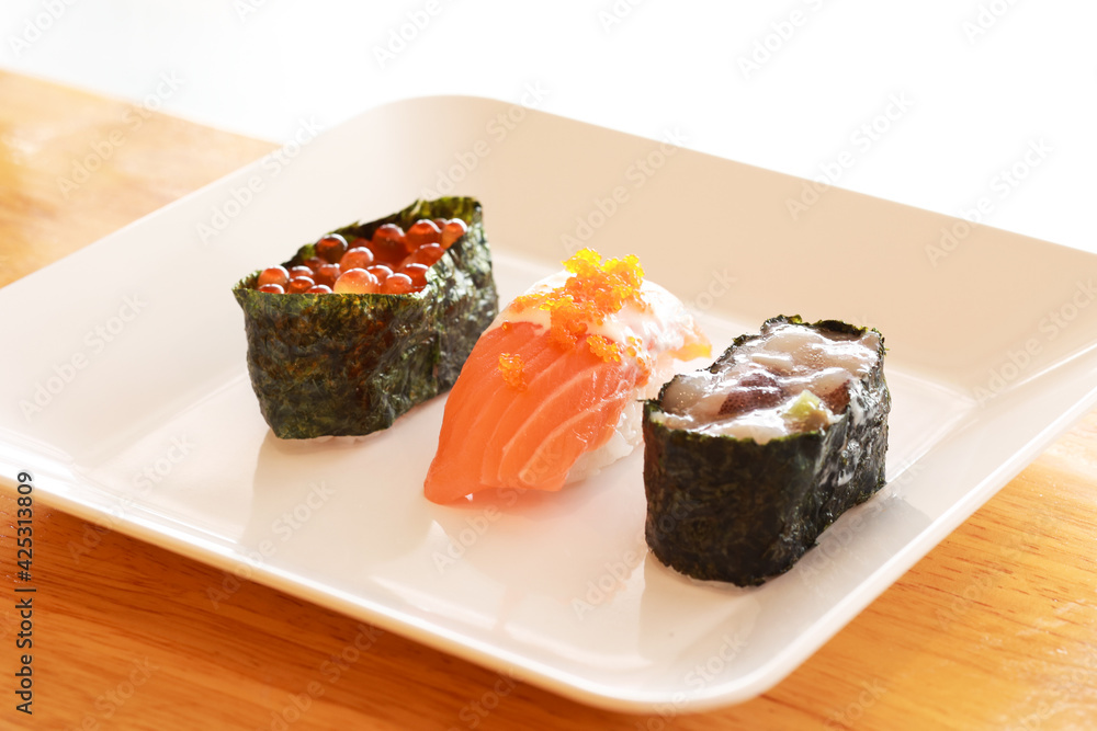 Various toppings of delicious sushi are placed on plates in Japanese restaurants. It is a very popular dish of Japan. Various toppings of delicious sushi are placed on plates in Japanese restaurants. It is a very popular dish of Japan.