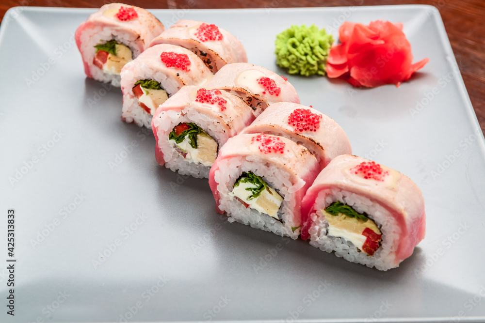 Salmon, tuna, sushi rolls set. On wooden background Salmon, tuna, sushi rolls set. On wooden background