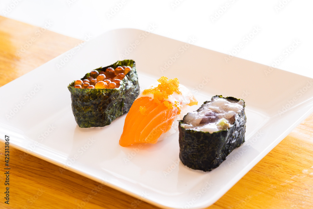 Various toppings of delicious sushi are placed on plates in Japanese restaurants. It is a very popular dish of Japan. Various toppings of delicious sushi are placed on plates in Japanese restaurants. It is a very popular dish of Japan.