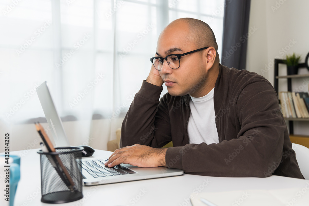 The young man was working in front of the laptop, he was tired. And fell asleep on the desk He needs rest The young man was working in front of the laptop, he was tired. And fell asleep on the desk He needs rest