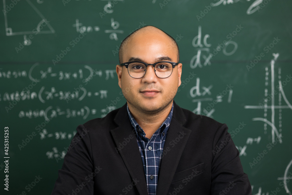 Indian young teacher man looking at camera sitting teaching online video conference live stream. Asian teacher teaching class webinar online for students learning.