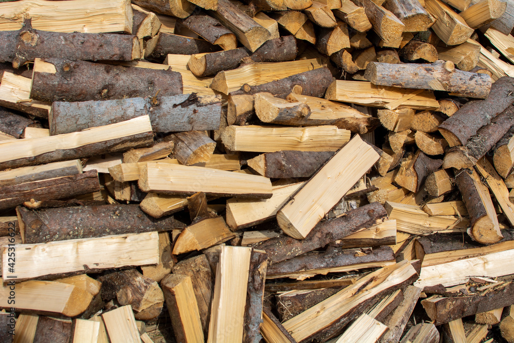 Pile of chopped firewood. Background texture wood. Pile of chopped firewood. Background texture wood.