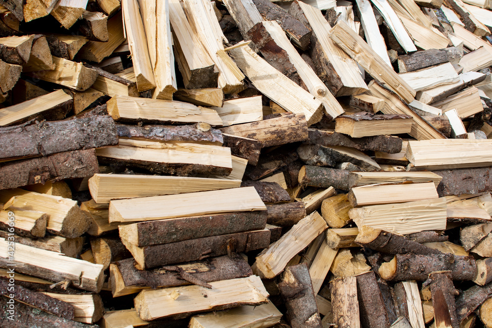 Pile of chopped firewood. Background texture wood. Pile of chopped firewood. Background texture wood.