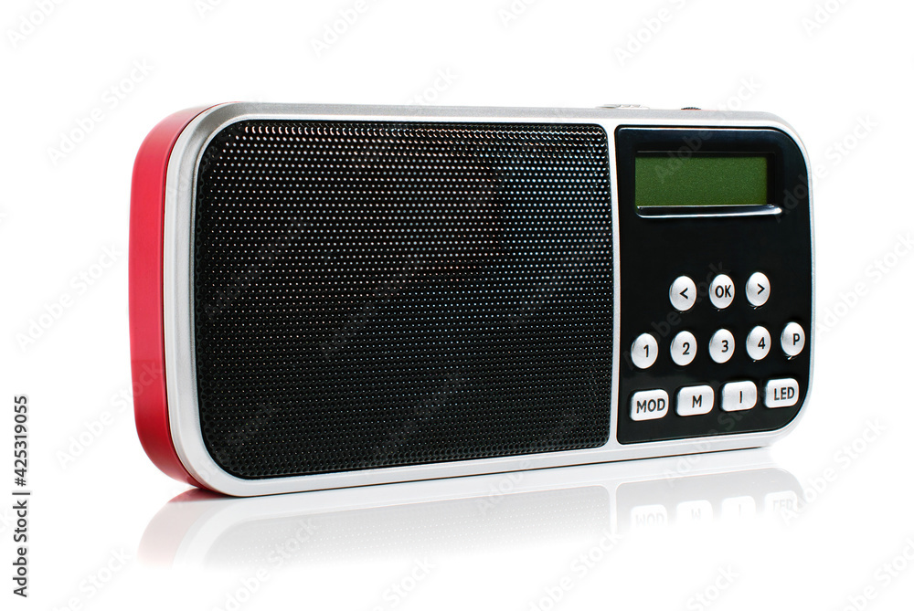 A small red metallic pocket digital radio on a white background A small red metallic pocket digital radio on a white background