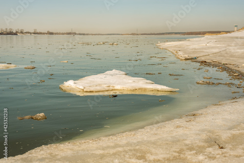 Spring melting. Ice floes float down the river in the city