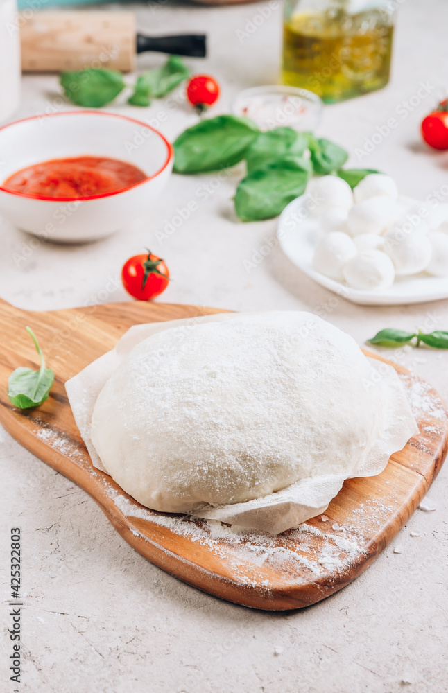 The ingredients for homemade Margherita pizza on stone background. The ingredients for homemade Margherita pizza on stone background.