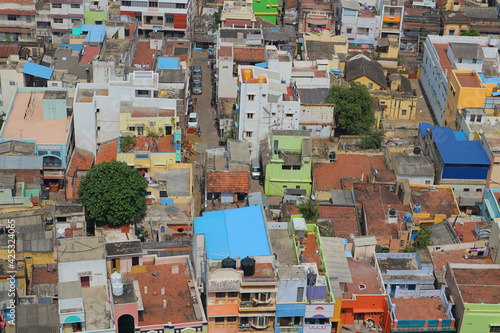 Top view of the Indian town. Roofs of houses, urban buildings, houses and cars in a small Indian city. Tiruchchirapalli from a bird's eye view. photo
