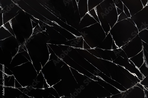 macro texture of broken dark glass with detailed cracks