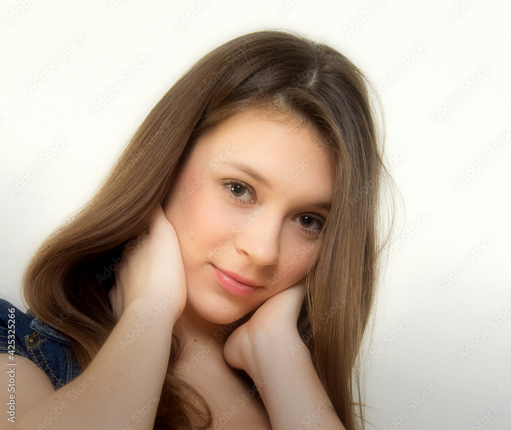 Portrait of a beautiful long-haired brunette in a blue jacket. Portrait of a beautiful long-haired brunette in a blue jacket.