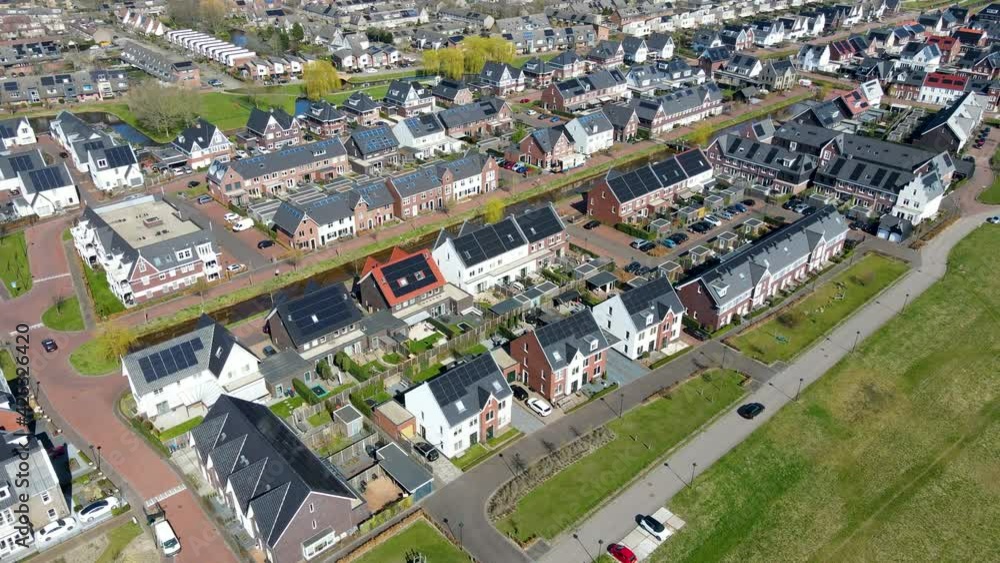 Aerial of car driving through neighborhood with solar panels on rooftop Aerial of car driving through neighborhood with solar panels on rooftop