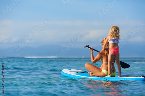 Canvas Print Active paddle boarder at sunset sea