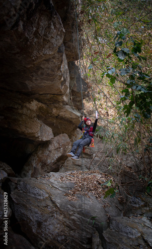 Beautiful young Asian climbers are climbing the high cliffs of northern Thailand.