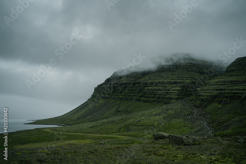 Beautiful nature dramatic landscape in Iceland. Low clouds, fog on the mountains. Cold toned filter © Ivan Kurmyshov