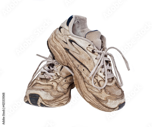 Old, worn sneakers on white background