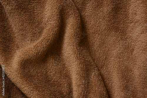 Plush wavy brown texture. Macro photo. Fabric background