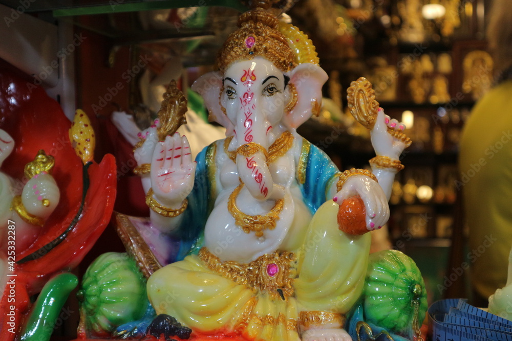 Figurine of God Ganesha. Indian souvenir. Beautiful Ganapati with four arms blesses with a gesture during Vinayaka chathurthi festival