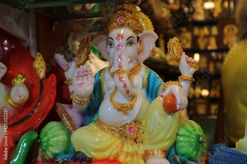 Figurine of God Ganesha. Indian souvenir. Beautiful Ganapati with four arms blesses with a gesture during Vinayaka chathurthi festival