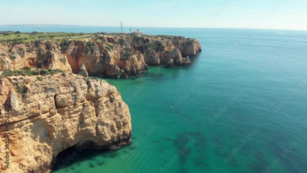 Farol Ponta da Piedade, lighthouse overlooking the Atlantic Ocean emerald waters, Lagos, Algarve Farol Ponta da Piedade, lighthouse overlooking the Atlantic Ocean emerald waters, Lagos, Algarve