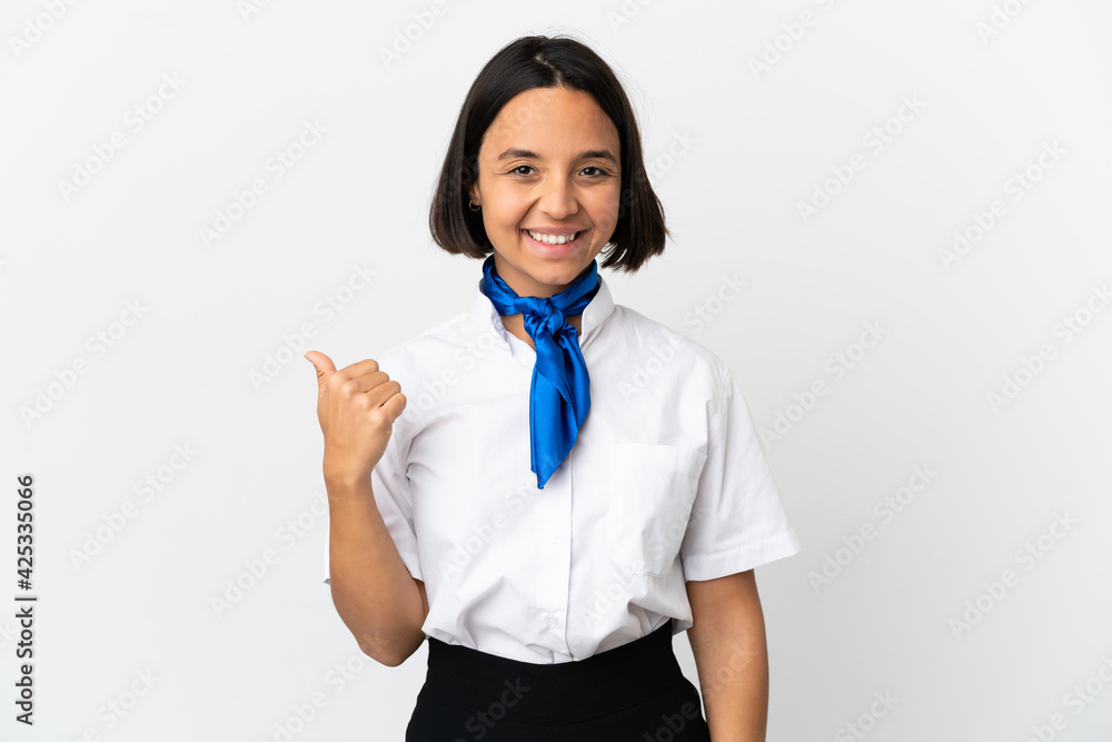 Airplane stewardess over isolated background pointing to the side to present a product Airplane stewardess over isolated background pointing to the side to present a product