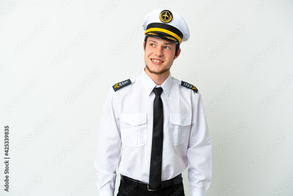 Airplane Russian pilot isolated on white background thinking an idea while looking up
