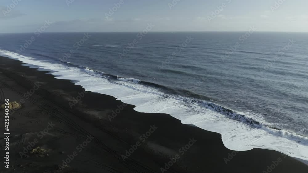 Big Foamy Waves Splashing On Black Sand Beach In Iceland - panning shot Big Foamy Waves Splashing On Black Sand Beach In Iceland - panning shot