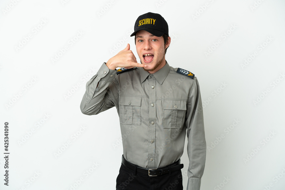 Young Russian security man isolated on white background making phone gesture. Call me back sign Young Russian security man isolated on white background making phone gesture. Call me back sign