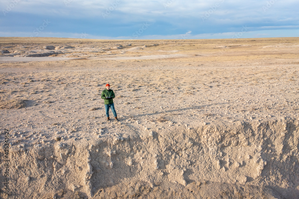 senior male drone pilot in a rugged terrain of Pawnee National Grassland in northern Colorado