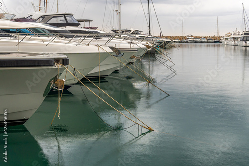 Luxury yachts moored in a marina on the island of Mallorca on a rainy day
