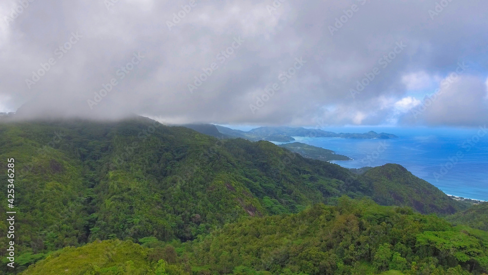 Mahe', Seychelles. Aerial view of mountains and coastline on a foggy day Mahe', Seychelles. Aerial view of mountains and coastline on a foggy day