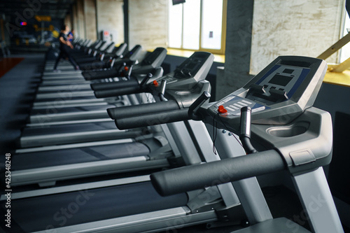 Row of treadmills in gym, running machine
