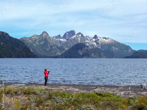 woman taking pictures at lago Tromen lake, Lanin national park, Argentina © Chris Peters