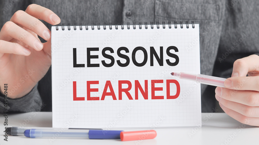 a card in the hands of a man with the inscription lessons learned a card in the hands of a man with the inscription lessons learned