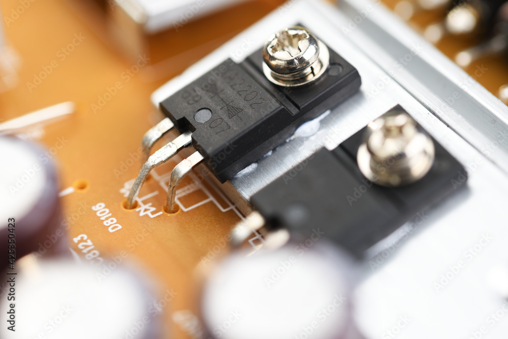 Electronic components and processor on a printed circuit. Close-up of electronic components on a TV, computer board. Integrated circuit. Information engineering. Semiconductor. PCB. Electronic components and processor on a printed circuit. Close-up of electronic components on a TV, computer board. Integrated circuit. Information engineering. Semiconductor. PCB.