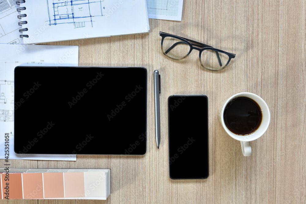 a top view of architect working desk with equipments for drawings pens sketched idea on wood table, the concept of modern technology for architectural working with tablet a top view of architect working desk with equipments for drawings pens sketched idea on wood table, the concept of modern technology for architectural working with tablet