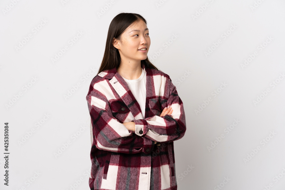 Young Chinese girl over isolated white background with arms crossed and happy Young Chinese girl over isolated white background with arms crossed and happy