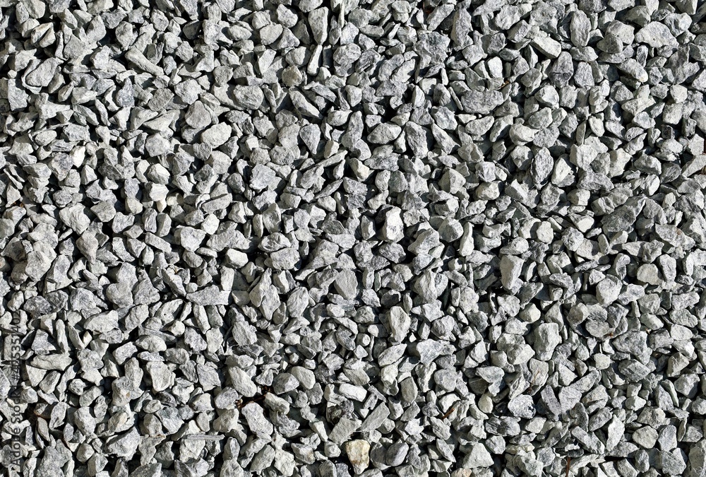 Monochrome light gray decorative pebbles used in the garden or yard. Background and texture Monochrome light gray decorative pebbles used in the garden or yard. Background and texture