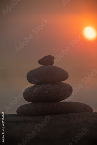A pillar of rocks with a sunset taking place in the background