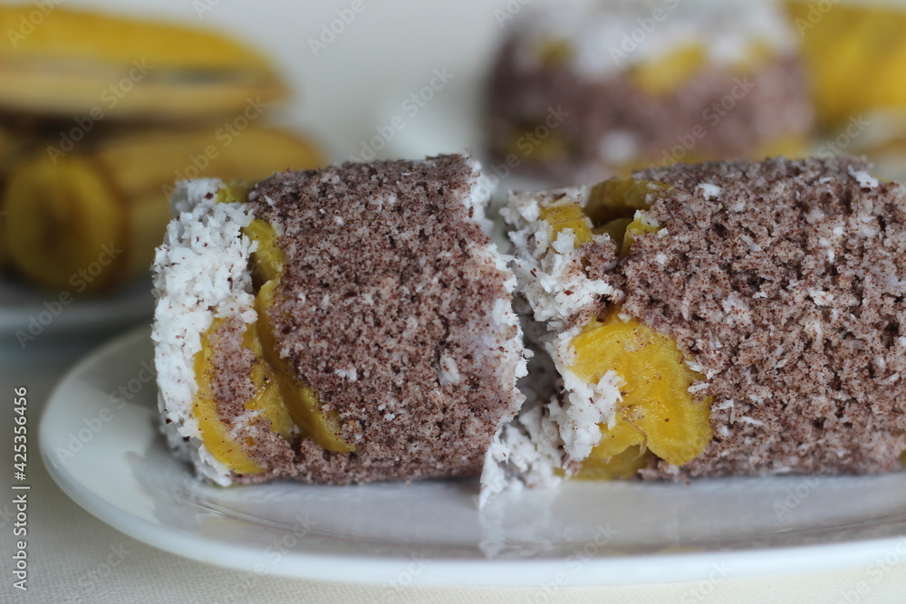 Steamed finger millet flour cake with a generous layer of fresh coconut