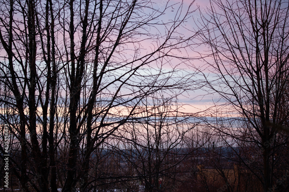 Clouds of different colors in the light of the sunset in April Clouds of different colors in the light of the sunset in April