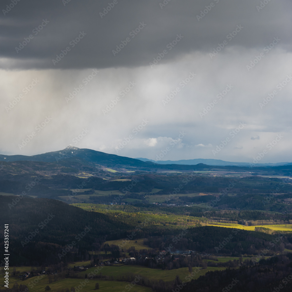 Mount Jested in the Bohemian Lusatian Mountains as seen from Mount Hochwald with storm clouds and rain plumes